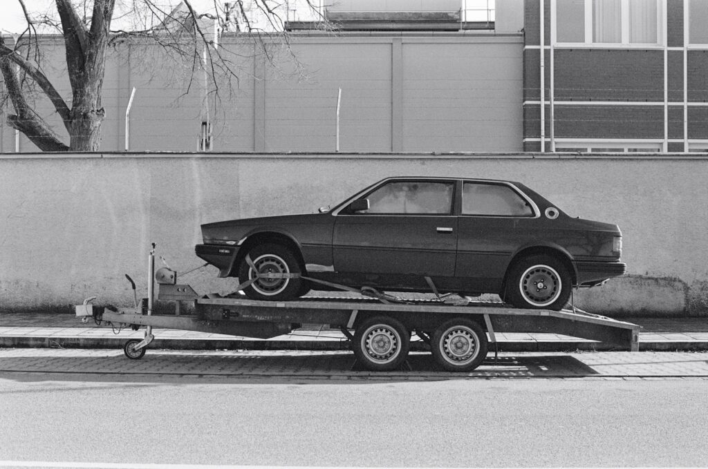 a car is being towed on a flatbed trailer