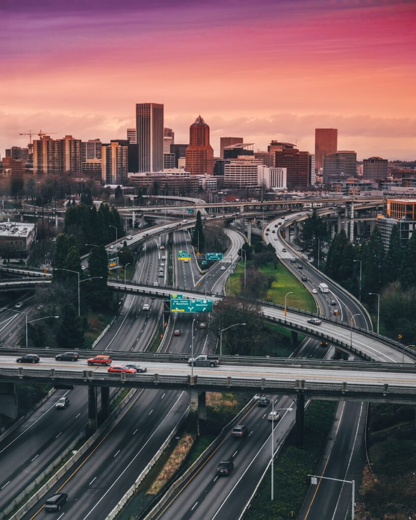 a city skyline with a freeway and a bridge