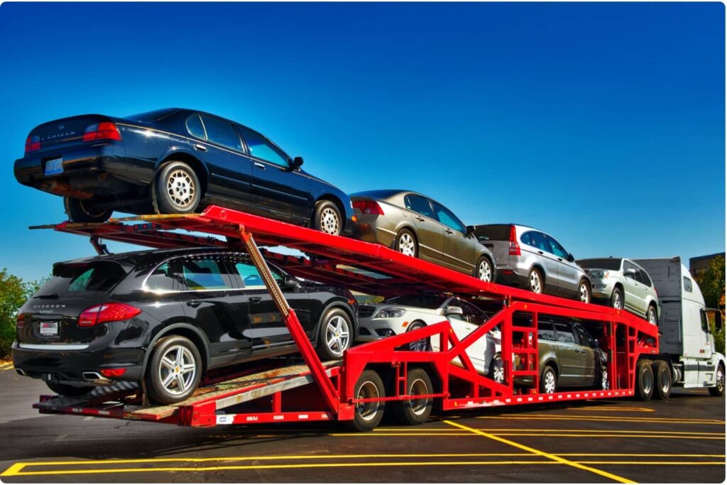 A car being loaded onto a transport truck for shipping from Georgia to North Carolina.