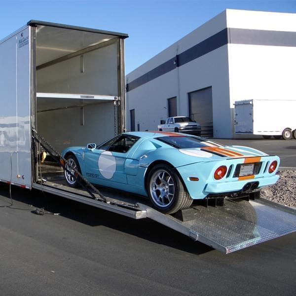 Navi Auto Transport vehicle being loaded into an enclosed transport trailer