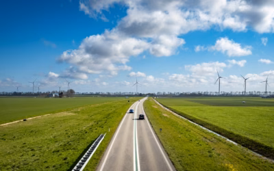 Fleet of open and enclosed car transport trucks driving along a highway, delivering vehicles across the U.S.