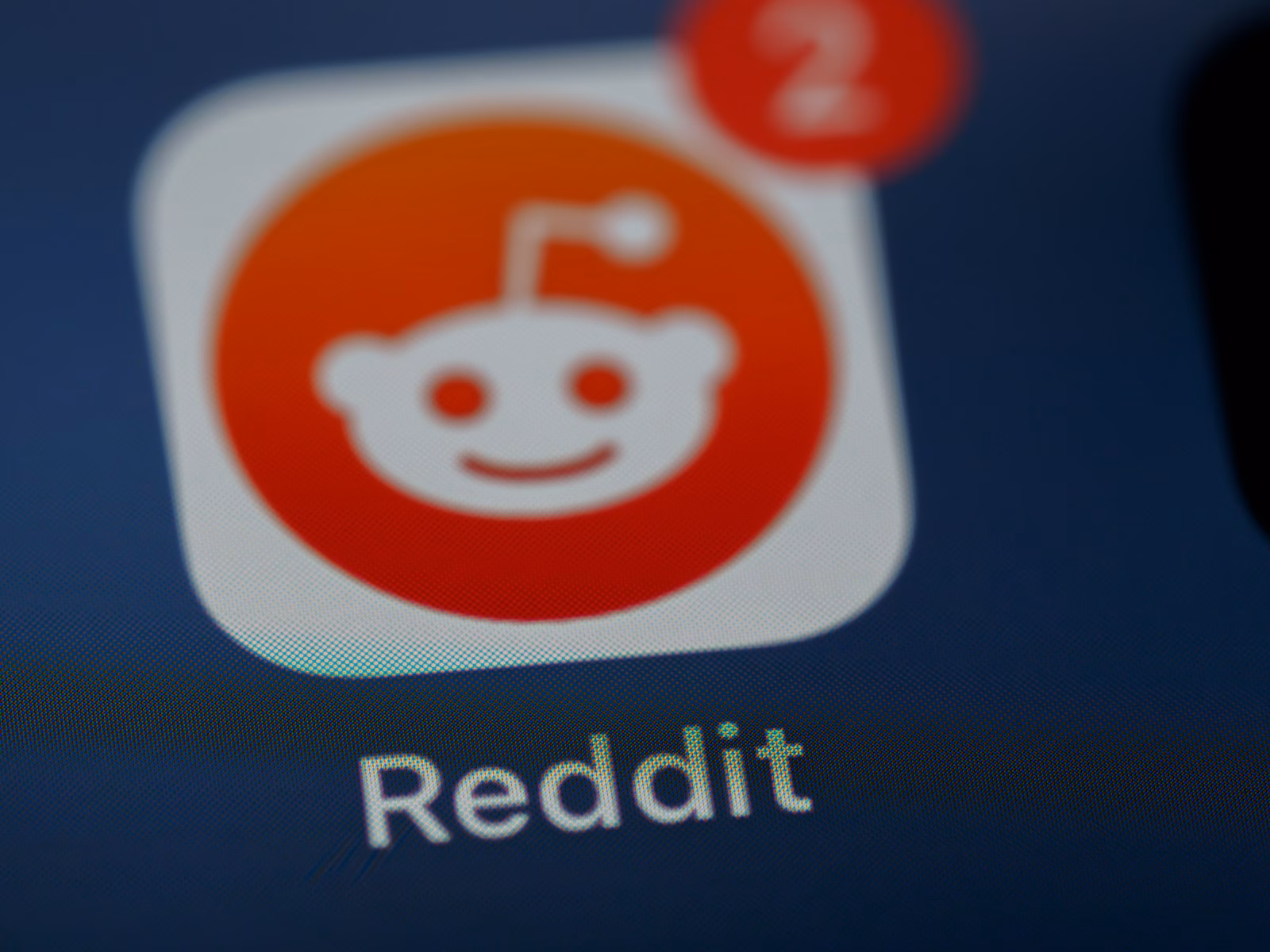 Bold dark blue background with the Reddit mascot (Snoo) beside large white text stating: 
