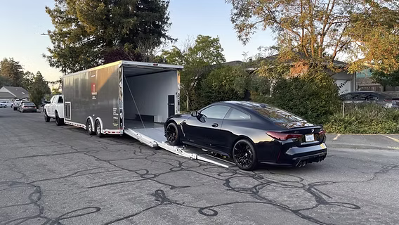 Navi auto transport loads a vehicle onto the trialer